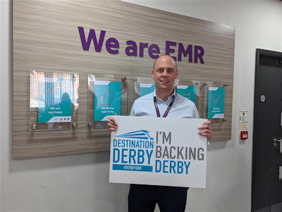 EMR employee holding an 'I'm backing Derby' sign